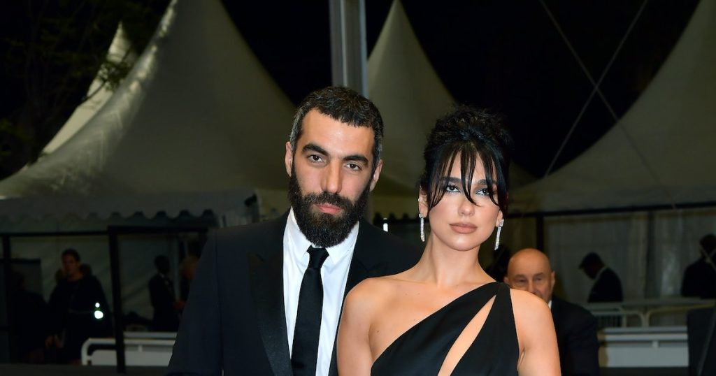 Shots Of Dua Lipa & Romain Gavras’ Crimson Carpet Debut At Cannes